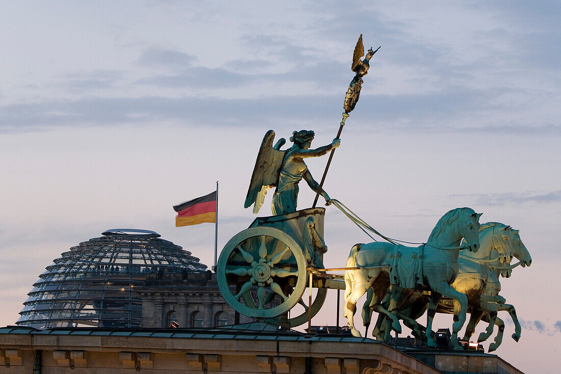 Quadriga, horse and chariot sculpture on Brandenburg Gate, in the background the Reichstag, Berlin