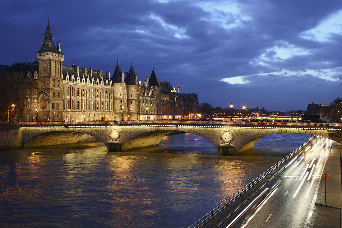 The night view of Conciergerie with River Seine and Pont du Change in foreground. Paris. France
