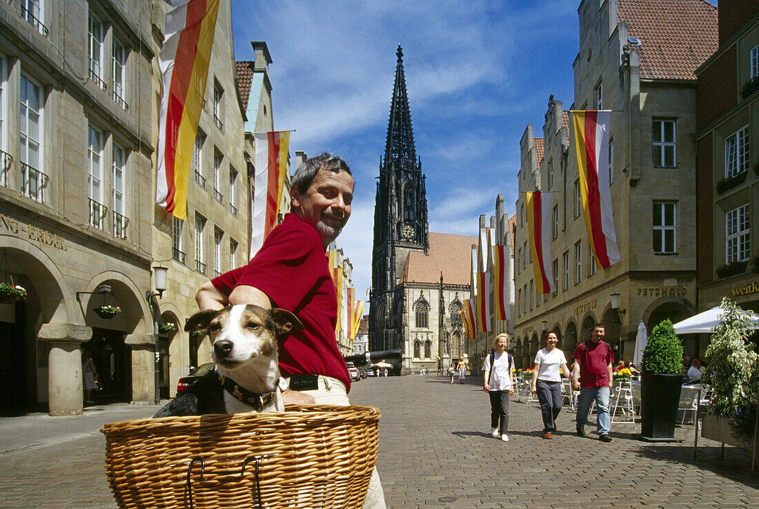 Cyclist with dog, Prinzipal market, Muenster, Muensterland, North Rhine-Westphalia, Germany