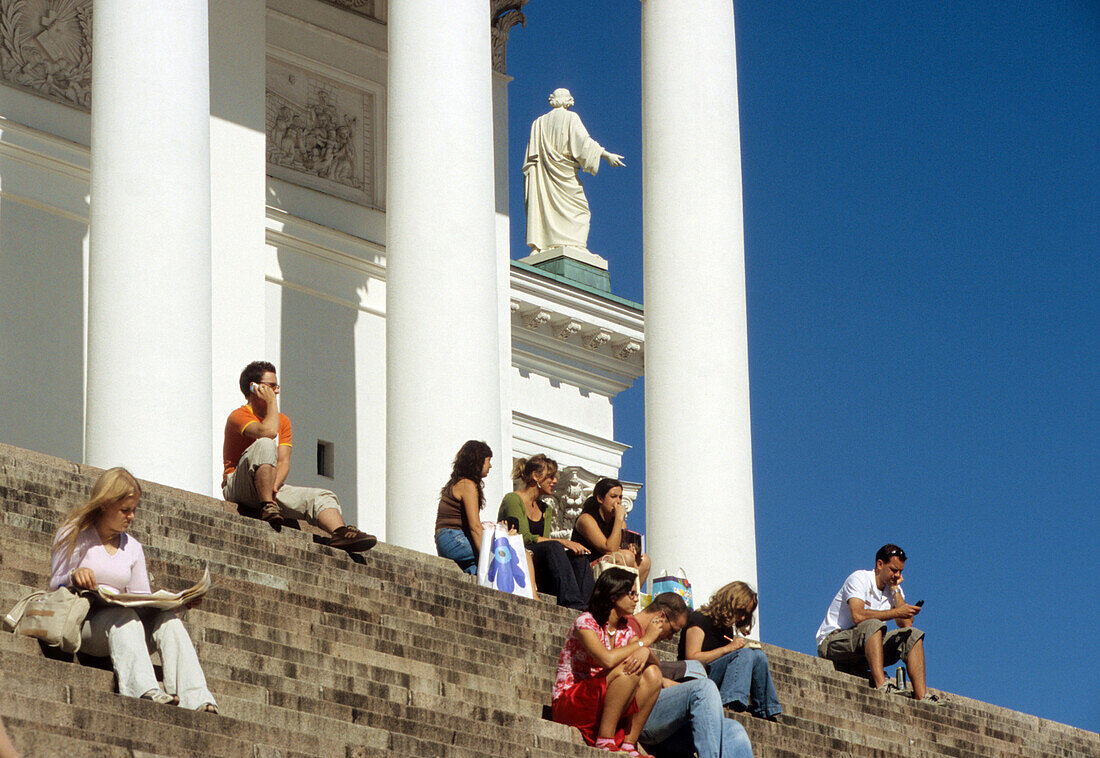 People sitting on the stairs in front of the cathedral, Helsinki, Finland, Europe