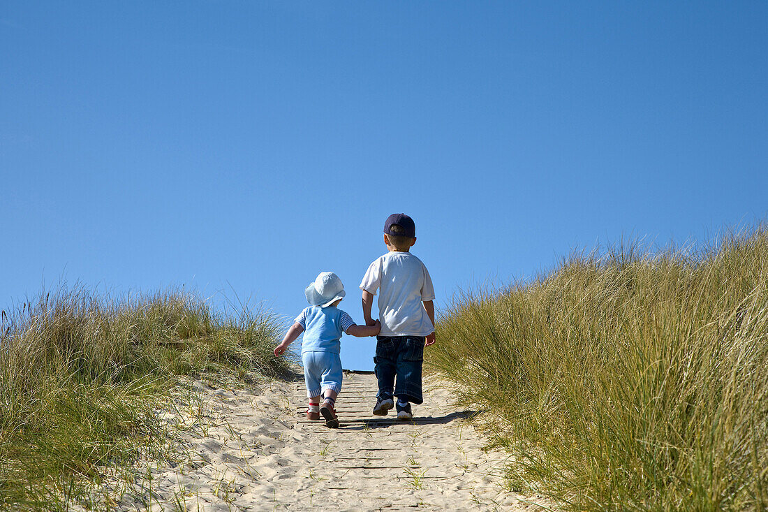 Children in dunes, Amrum island, North Frisian Islands, Schleswig-Holstein, Germany