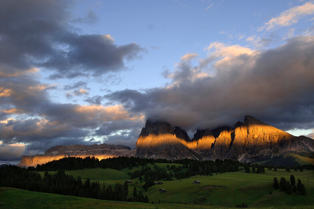 Mountain scenery at sunset under clouded sky, Dolomites, South Tyrol, Italy, Europe