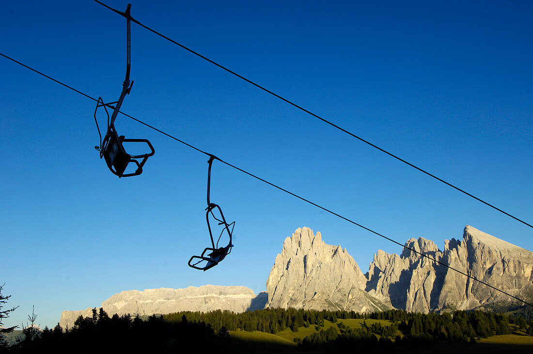 Chair lift in front of mountain scenery and blue sky, Val Gardena, Valle Isarco, South Tyrol, Italy, Europe