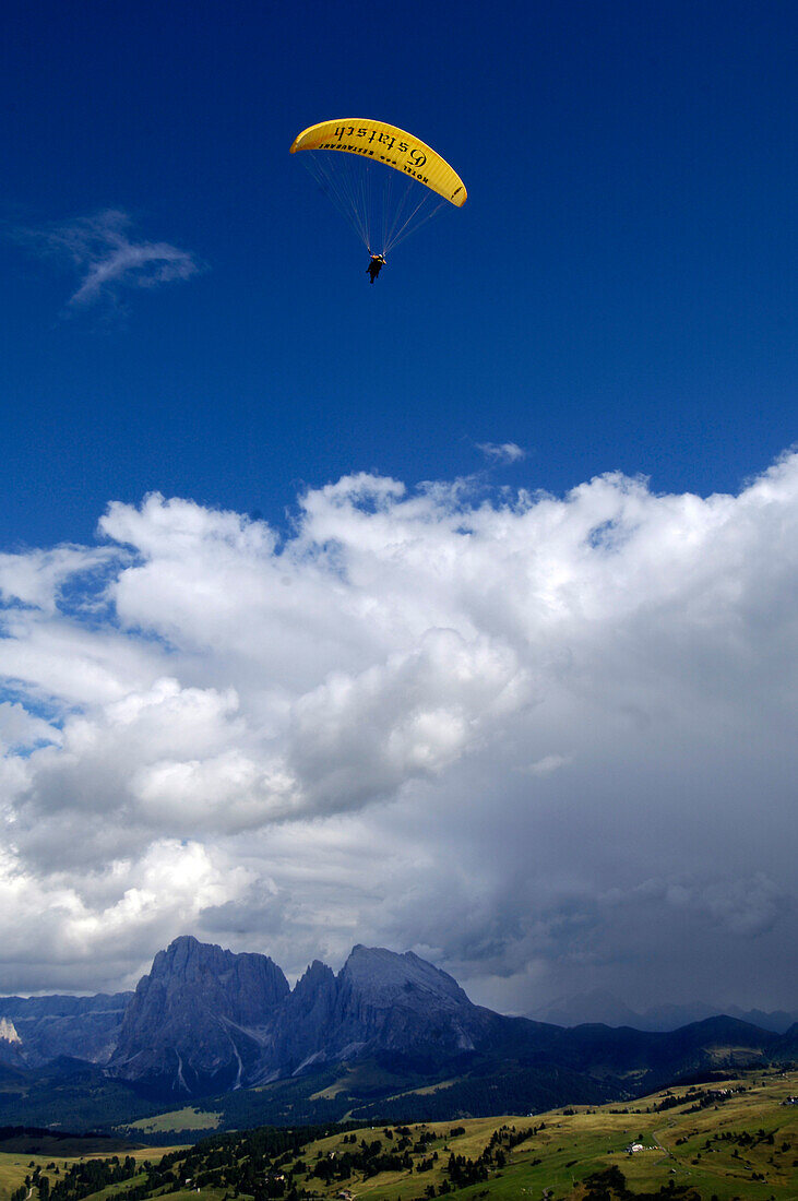 Paraglider in front of blue sky, Alpe di Siusi, Valle Isarco, South Tyrol, Italy, Europe