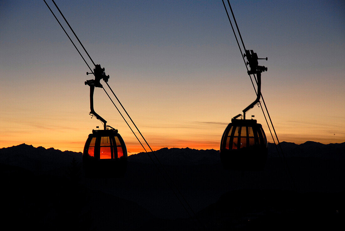 Passenger cabins of a cable car at sunset, South Tyrol, Italy, Europe