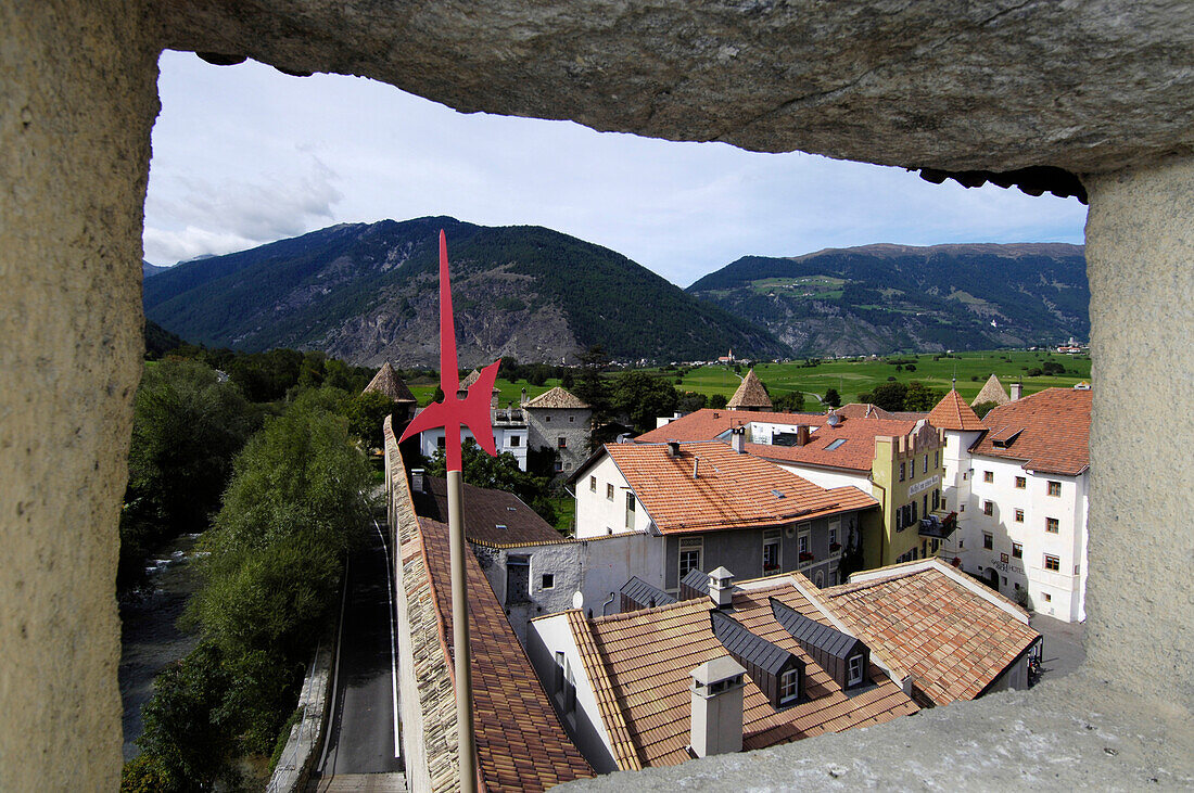 View through the city wall at the roofs of the Old Town, Glurns, Val Venosta, South Tyrol, Italy, Europe