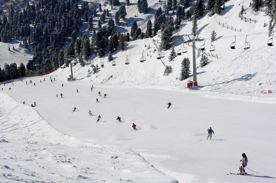 Skiers on a ski slope, Mountain landscape in Winter, Gherdeina, Val Gardena, South Tyrol, Italy