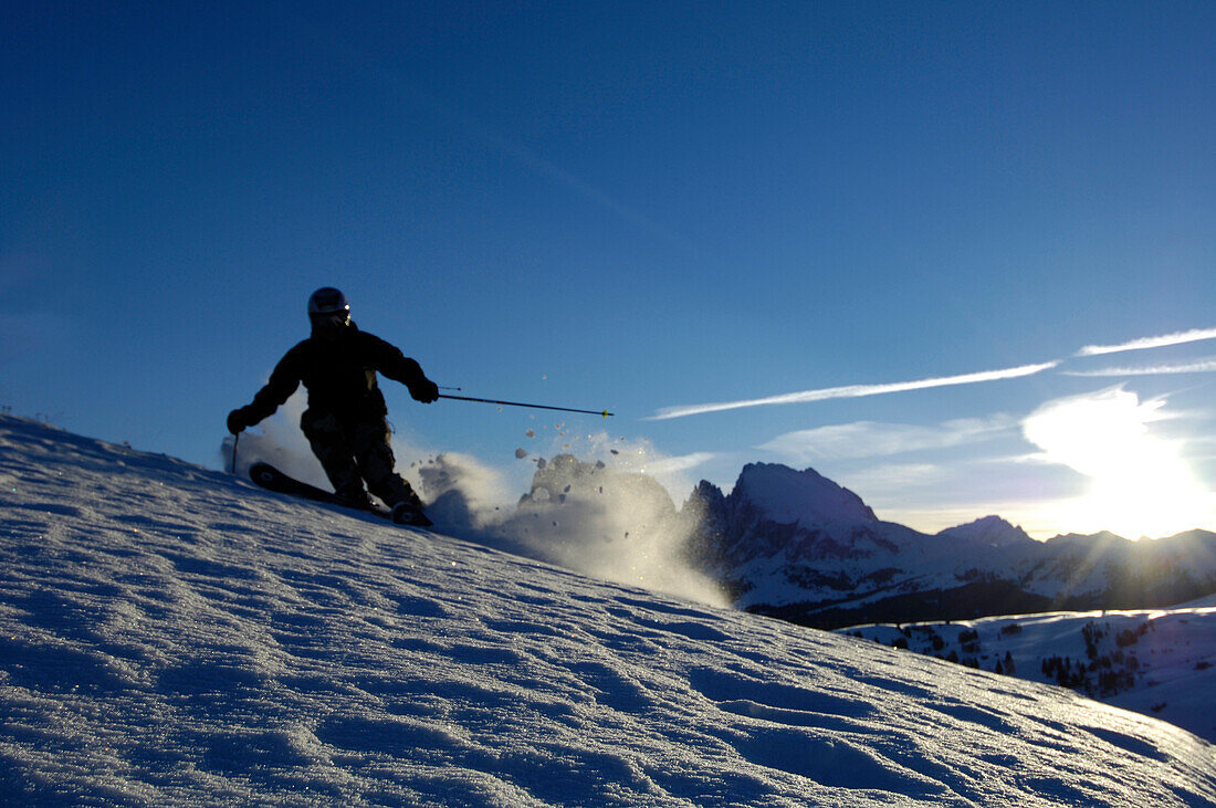 Skier skiing down a slope, Seiser Alm, Langkofel mountain range, South Tyrol, Italy
