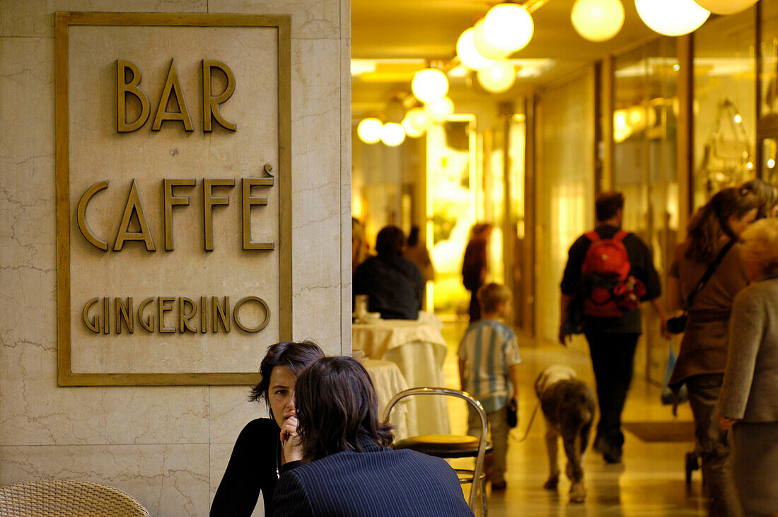 A couple sitting in Bar Caffé Gingerino, Europagalerie, Bolzano, South Tyrol, Italy