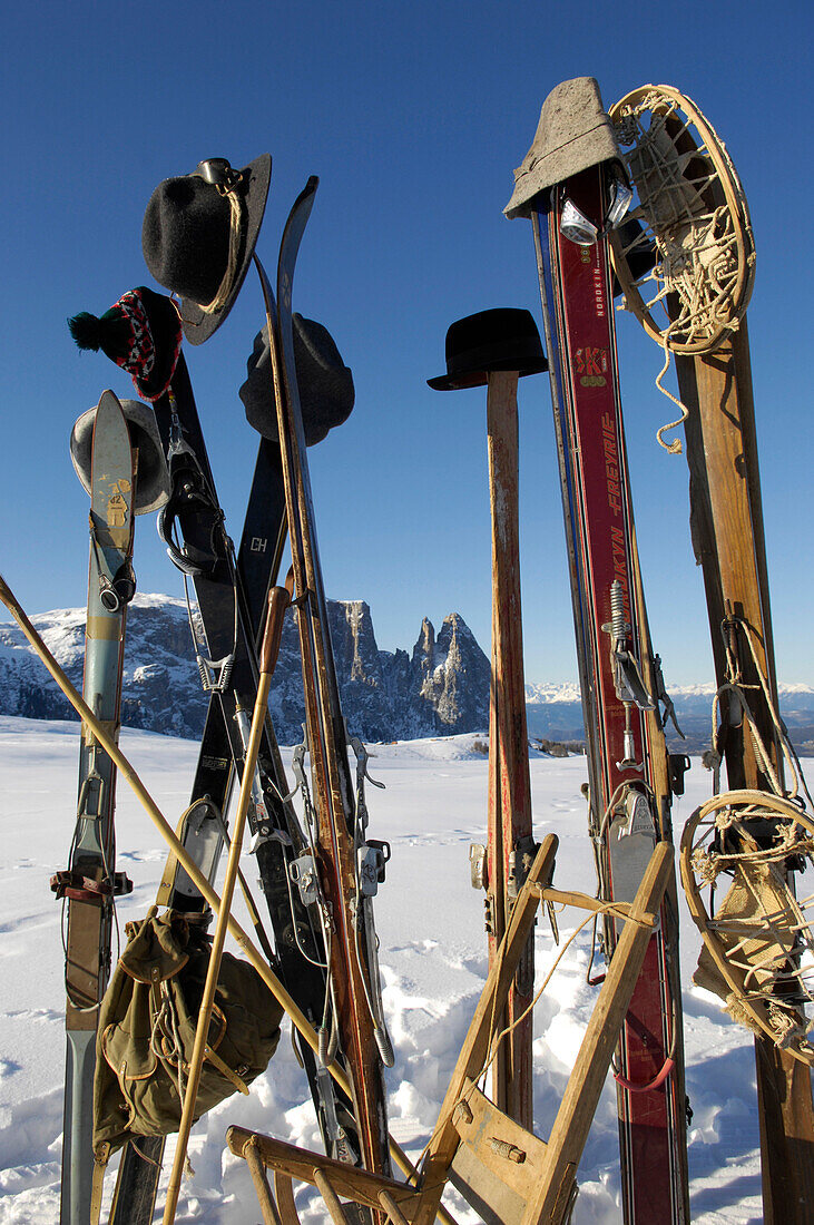 Wooden skis with hats in a winter mountain landscape, Nostalgia, Seiser Alm, Schlern, South Tyrol, Italy