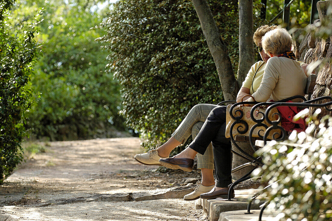 Two women sitting on a bench, Guntschna promenade, Bozen, South Tyrol, Italy