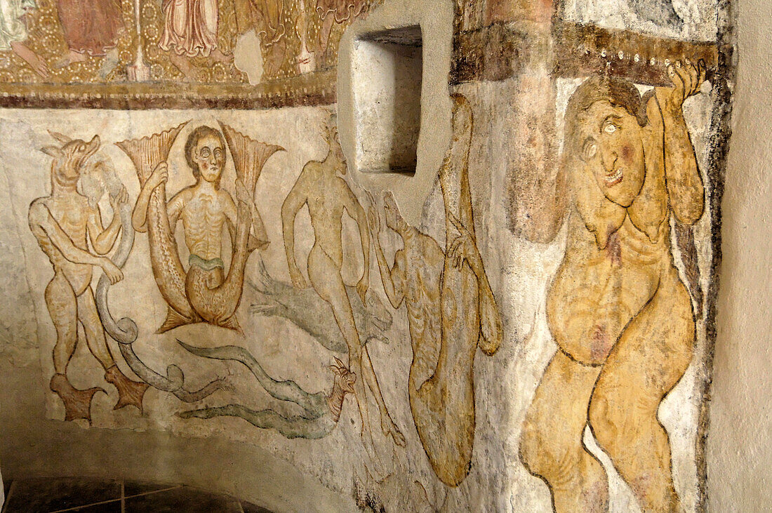 Romanesque frescos of demons in St. Jakobs chapel in Kastellaz, Tramin an der Weinstrasse, South Tyrol, Italy