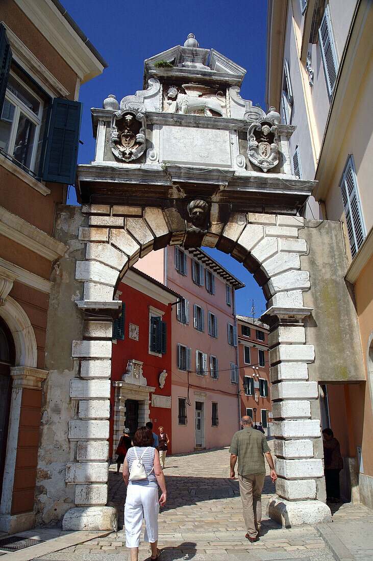 Looking through the Balbi Arch (1679) towards the old town of Rovinj, Istria, Croatia