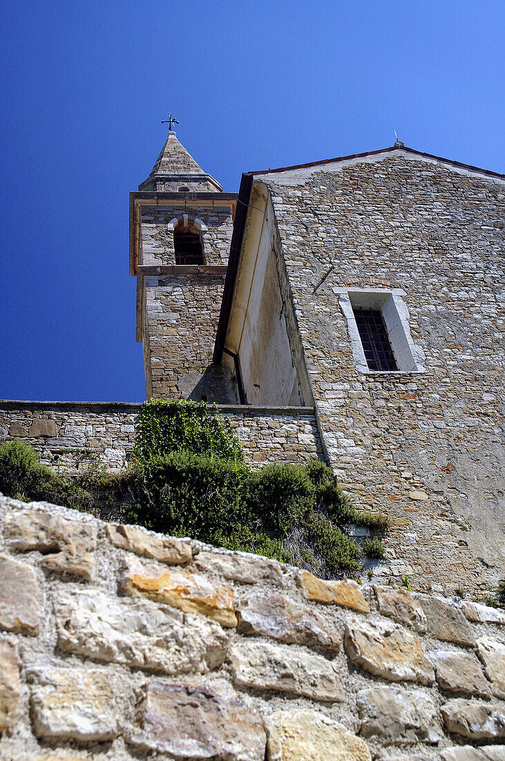 Steeple of St Stephen's Cathedral and old stone walls of Motovun, Istria, Croatia