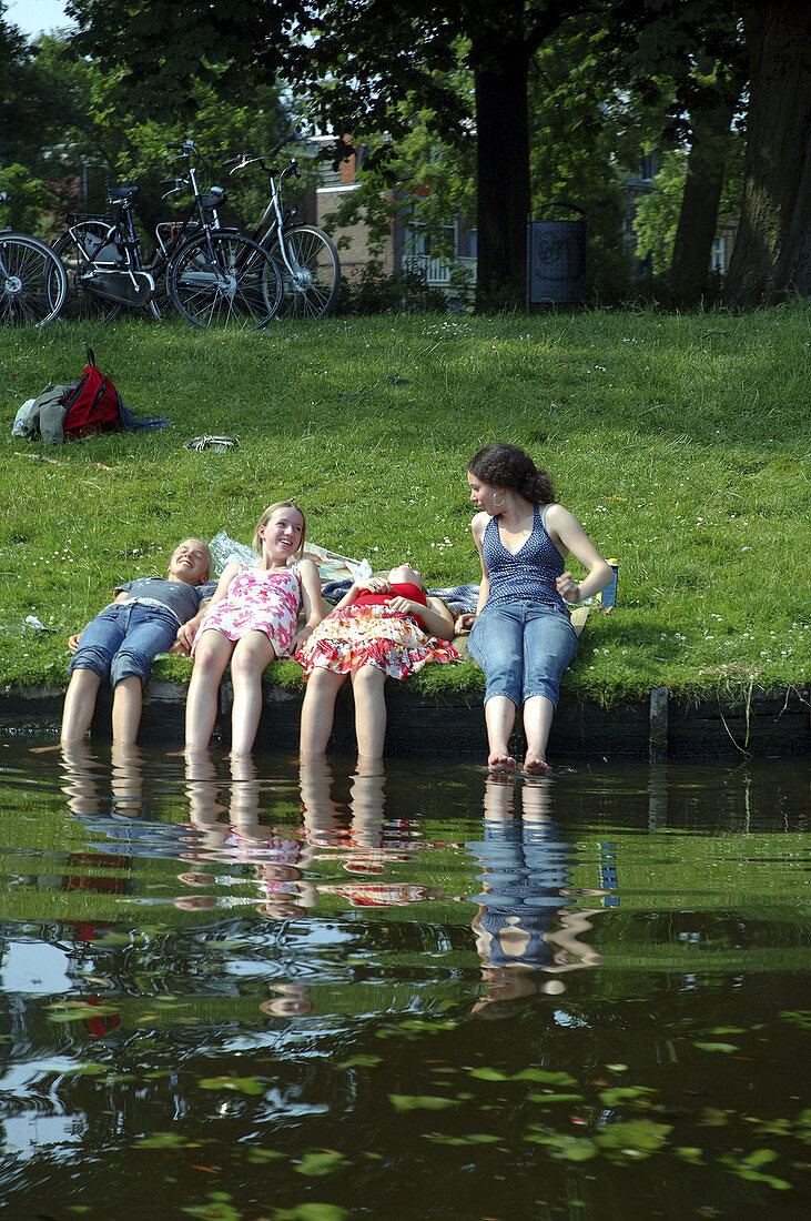 Young girls cooling off on a hot summer's day in Leiden, The Netherlands.