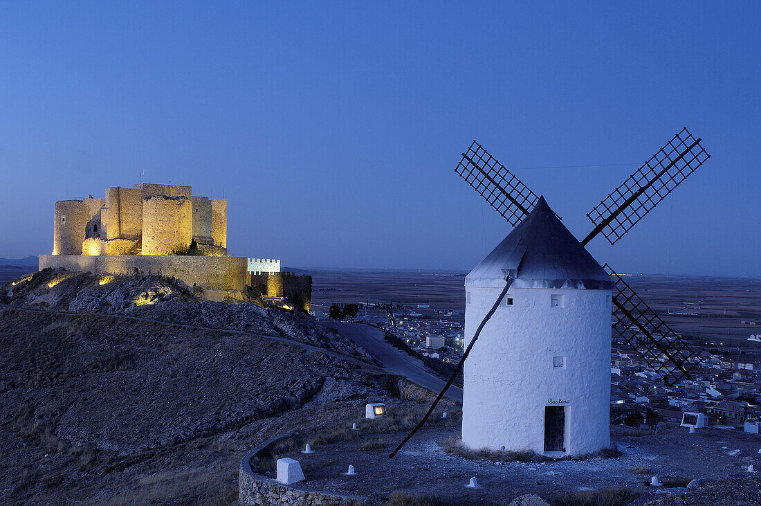 Windmill and castle at dusk, Consuegra. Toledo province, Castilla-La Mancha, Spain