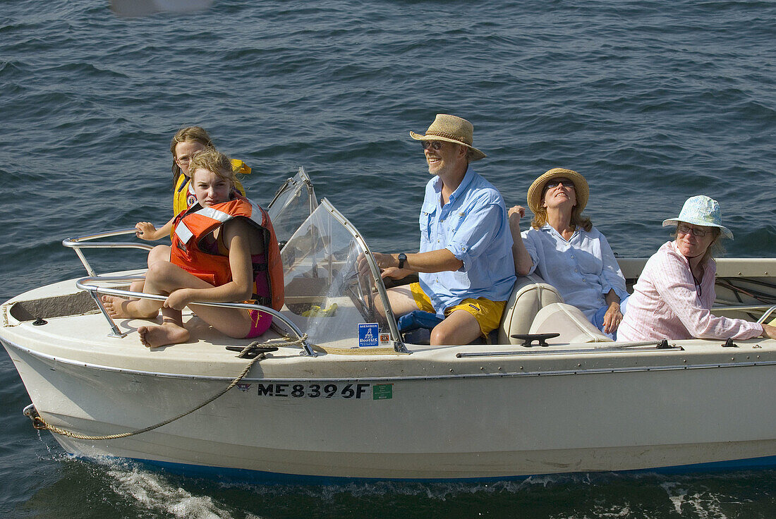 Family cruising in the motorboat on Penobscot Bay, Maine USA