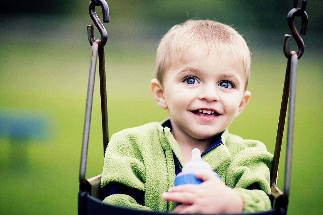 Caucasian, Caucasians, Child, Childhood, Children, Color, Colour, Contemporary, Daytime, Exterior, Facial expression, Facial expressions, Fair-haired, Feeding bottle, Feeding bottles, Happiness, Happ