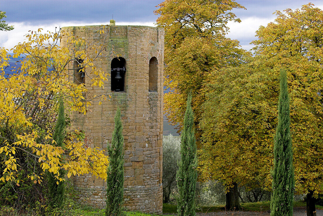 Pieve di Corsignano, Romanic church near Pienza, cypresses, walnut and  chestnut trees, colours of autumn, Tuscany, Italy
