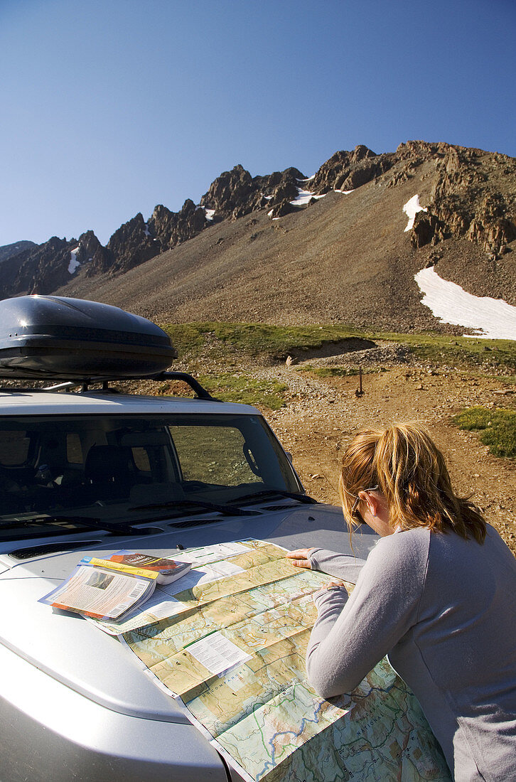 Female hiker planning a route up Mt  Sneffels in the Sneffels Wilderness, San Juan Mountains, Colorado, USA