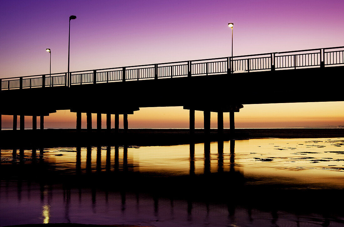 Bridge backlit at sunset. Costa Dorada de Catalunya (Spain).