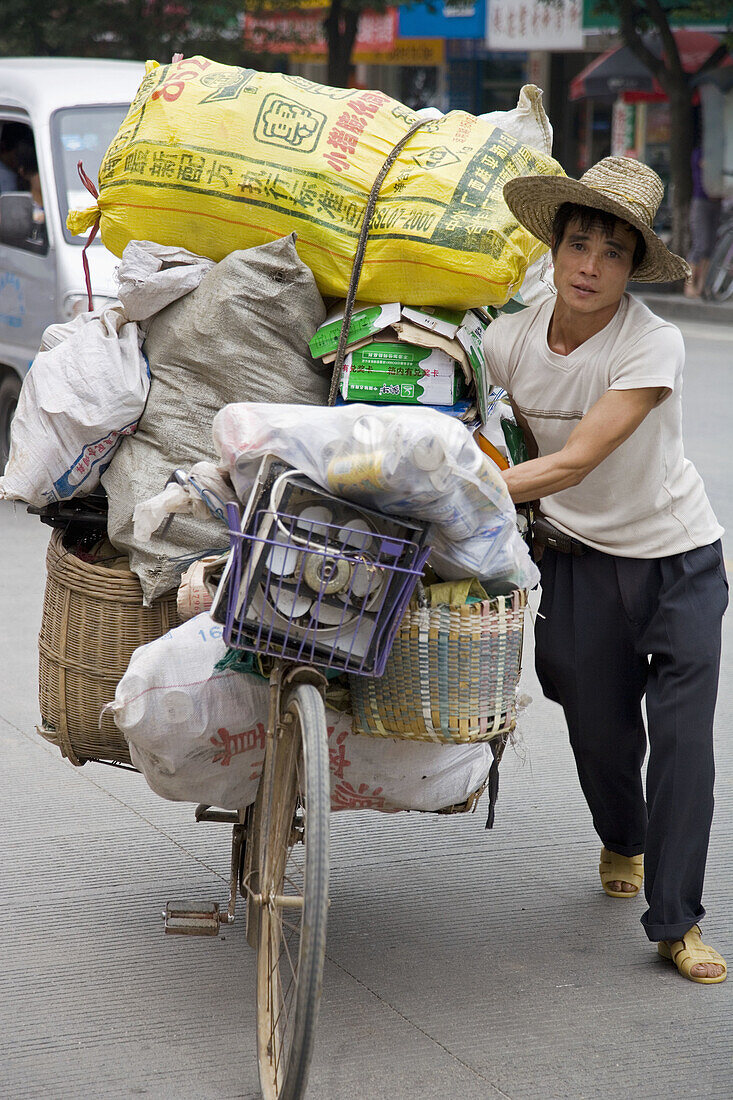 Man and his overloaded bicycle, Guilin, China