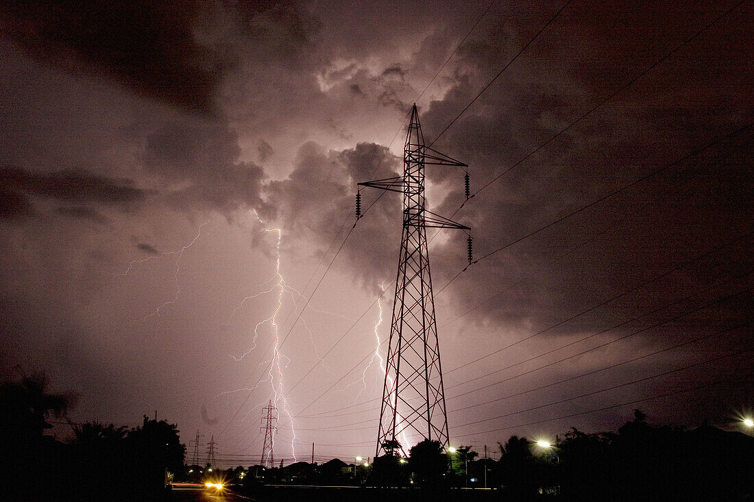Lightning strikes during thunder storm over a power line