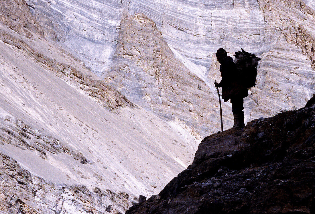 A trekker is looking down into a huge canyon formed buy the Zanskar river.In the winter time this Trek is called Chaddar by the locals.