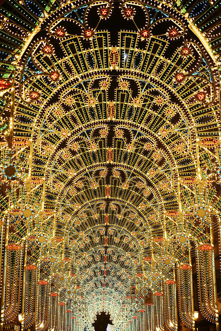 Light colorful decorated street in Valencia during 'Las Fallas'. Spain