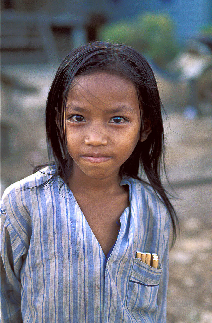 In order to support her family, this little girl sells cigarettes. Poverty is a problem in rural Cambodia.