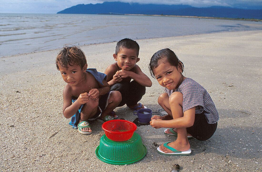 Kids having fun on a beautiful tropical beach in Langkawi, Malaysia