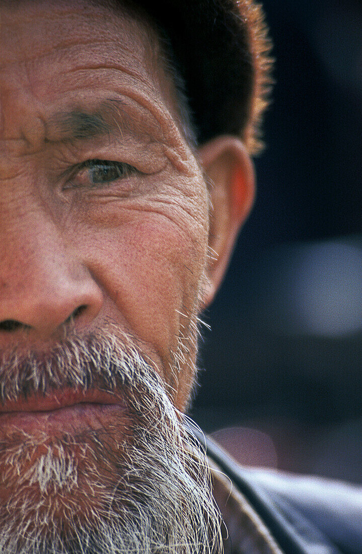 Half a portrait of a Uygur man in Kashrar, Xinjiang, China