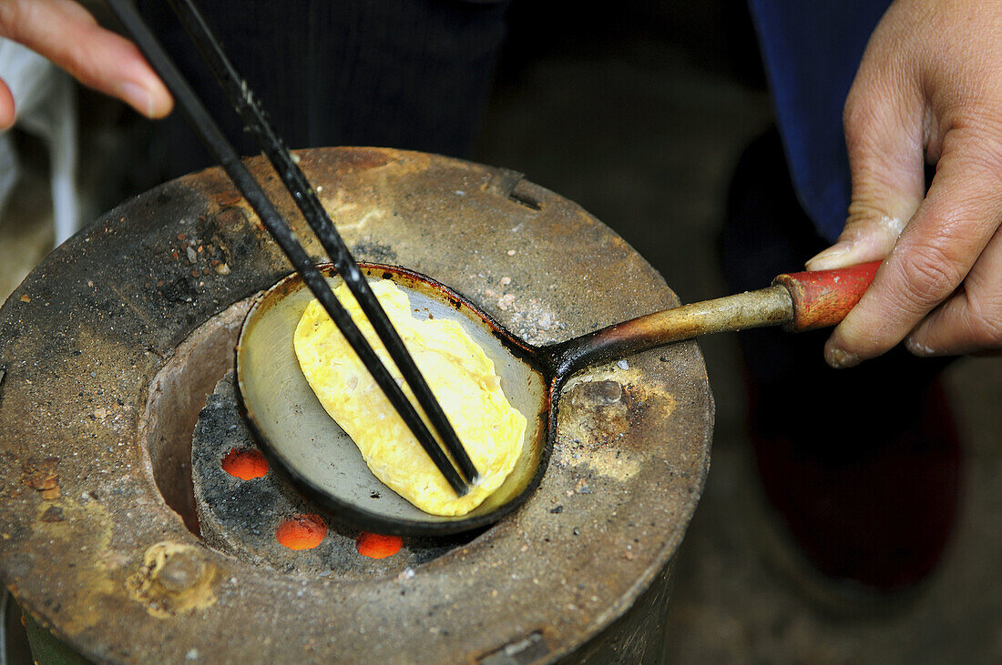 Cooking omlete in a small market street in Nanjing, China