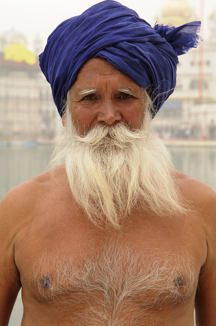 An old Sikh man in the Golden temple in Amritsar, India  As part of his visit to the Golden temple this man will take a bath in the holy pool which surrounds the temple