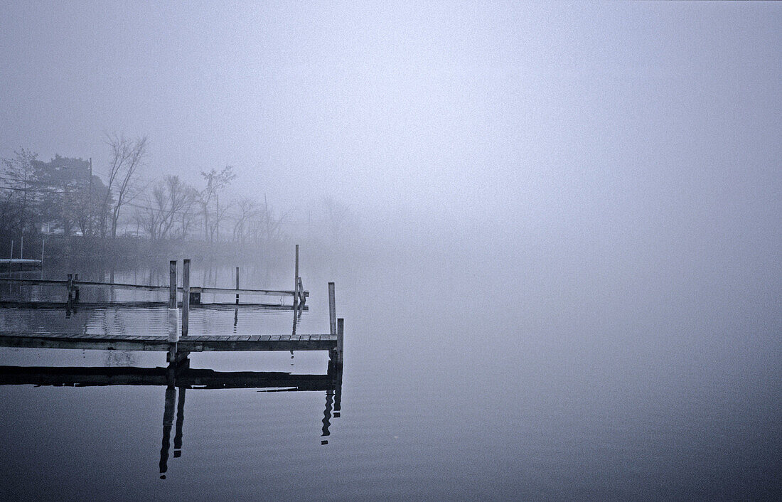 Docks on foggy lake