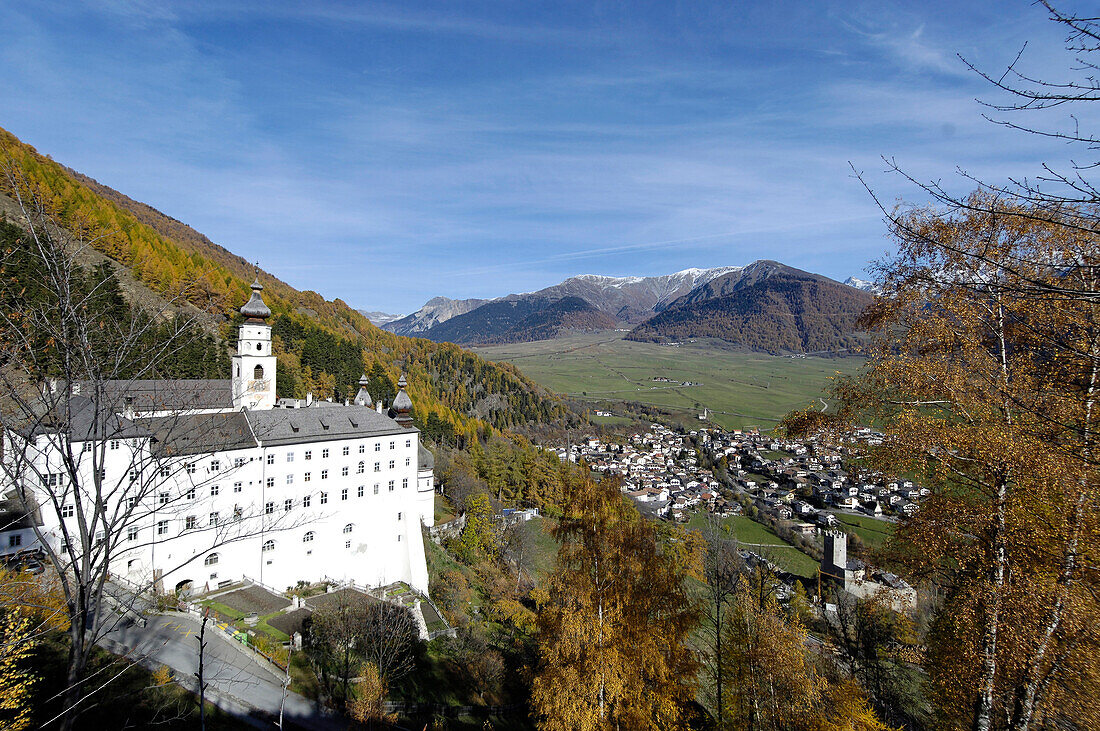 Marienberg abbey in the sunlight and view at a village in a valley, Burgeis, Mals, Val Venosta, South Tyrol, Italy, Europe