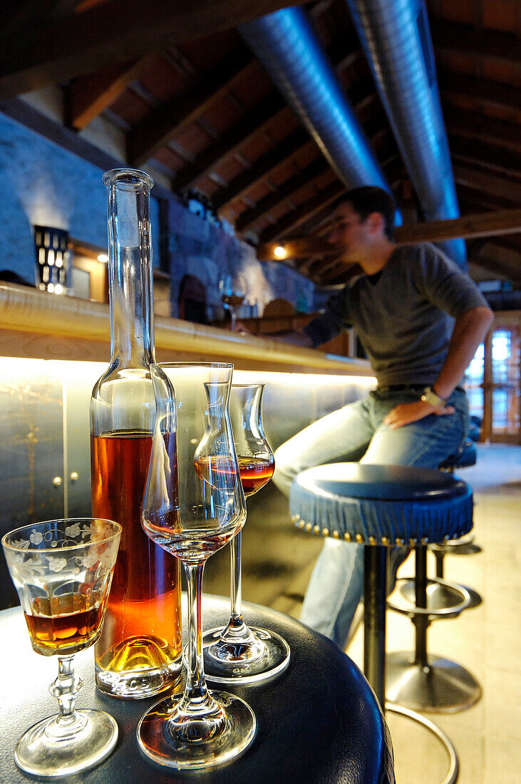 A man sitting in the bar of Hotel Bad Schörgau, Bad Schörgau, Valley Sarntal, South Tyrol, Italy, Europe