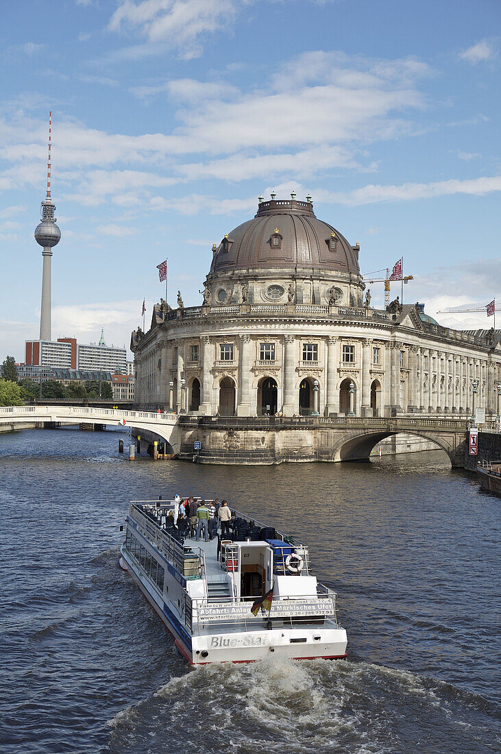 Museumsinsel, Mitte area, Berlin, Germany. View from Weidendammbrücke east to Bodemuseum, sightseeing ferry. Television tower in the background left.