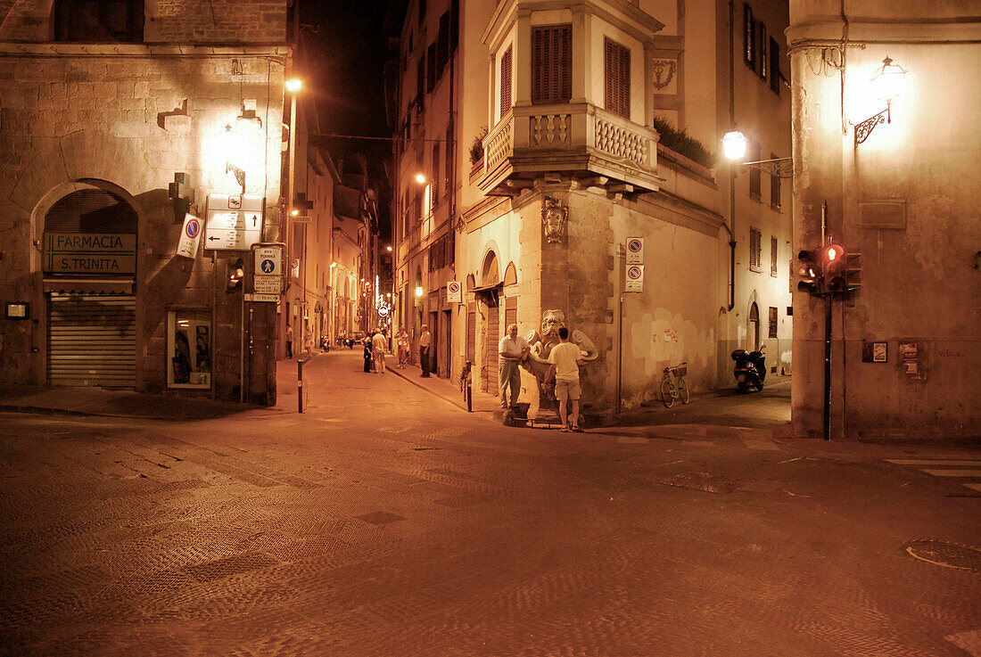 People standing at a crossroads at night, Florence, Tuscany, Italy, Europe