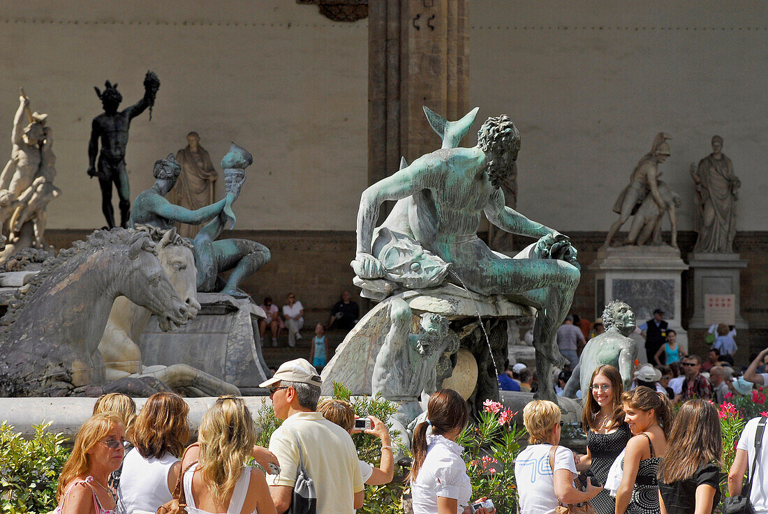 Tourists in front of Neptune fountain in the sunlight, Piazza della Signoria, Florence, Tuscany, Italy, Europe