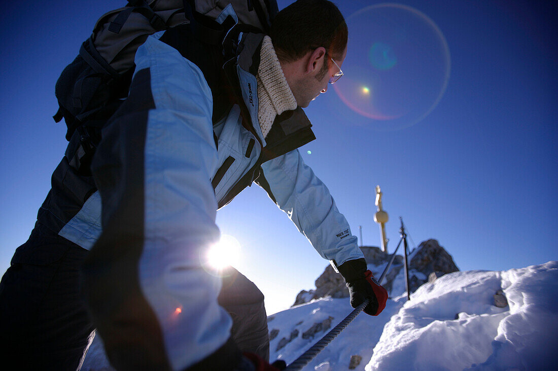 Man on summit of mount Zugspitze, Bavaria, Germany