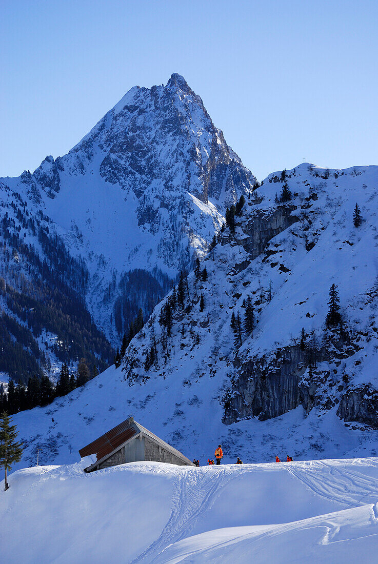 Group of  backcountry skiers in front of alpine hut, Grosser Rettenstein in background, Brechhorn, Kitzbuehel Alps, Tyrol, Austria
