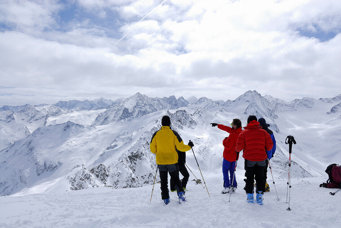 Group of backcountry skiers resting on summit of Lamsenspitze, Sellrain, Stubai range, Tyrol, Austria