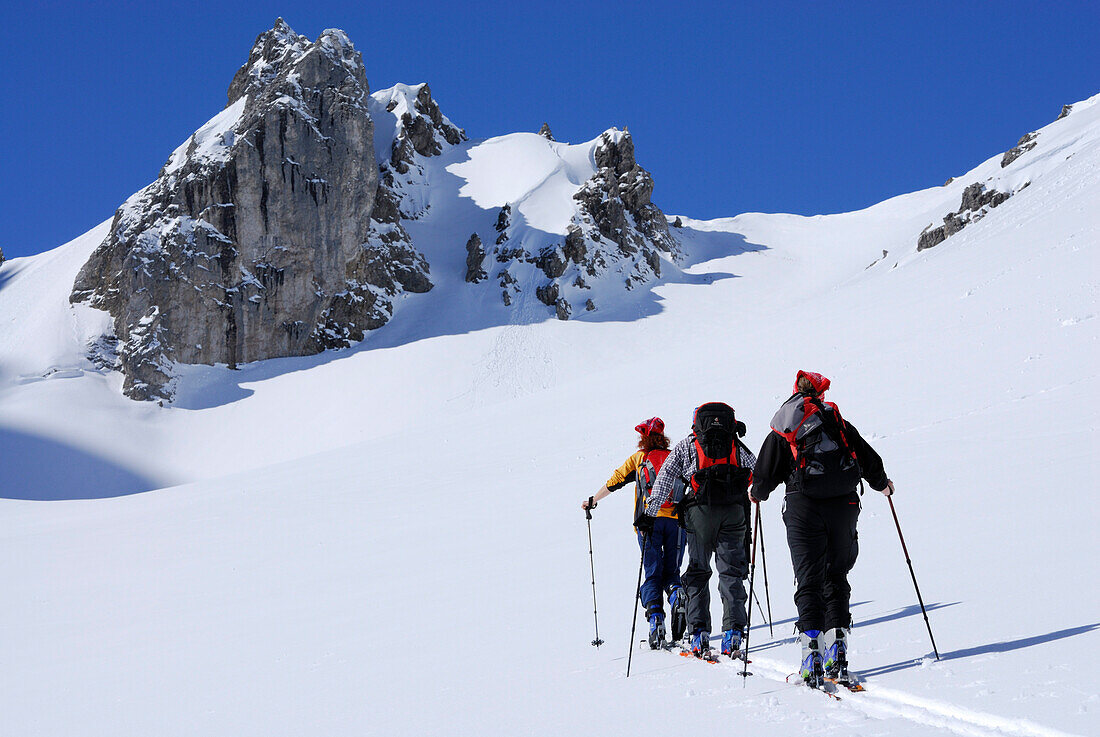Three backcountry skiers ascending, Tajatoerl, Mieminger range, Tyrol, Austria