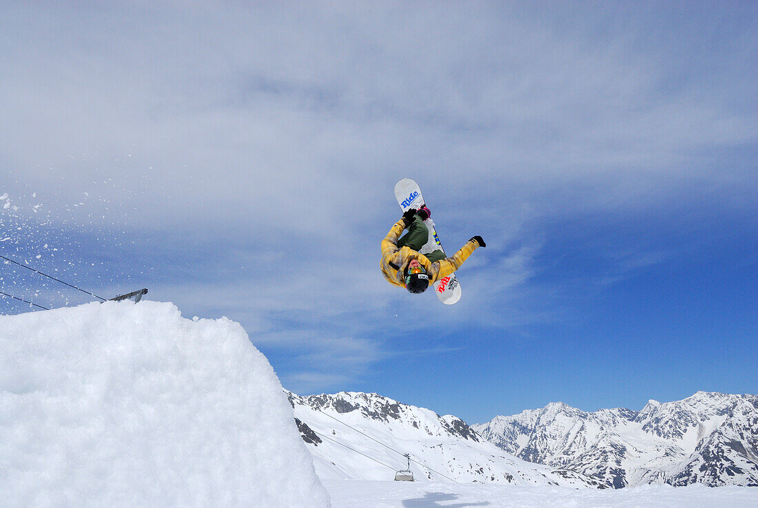 Snowboarder in mid-air, back-flip, ski area Soelden, Oetztal, Tyrol, Austria
