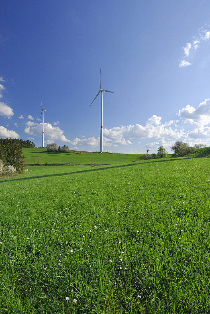 Two wind turbines in meadow, Bavaria, Germany