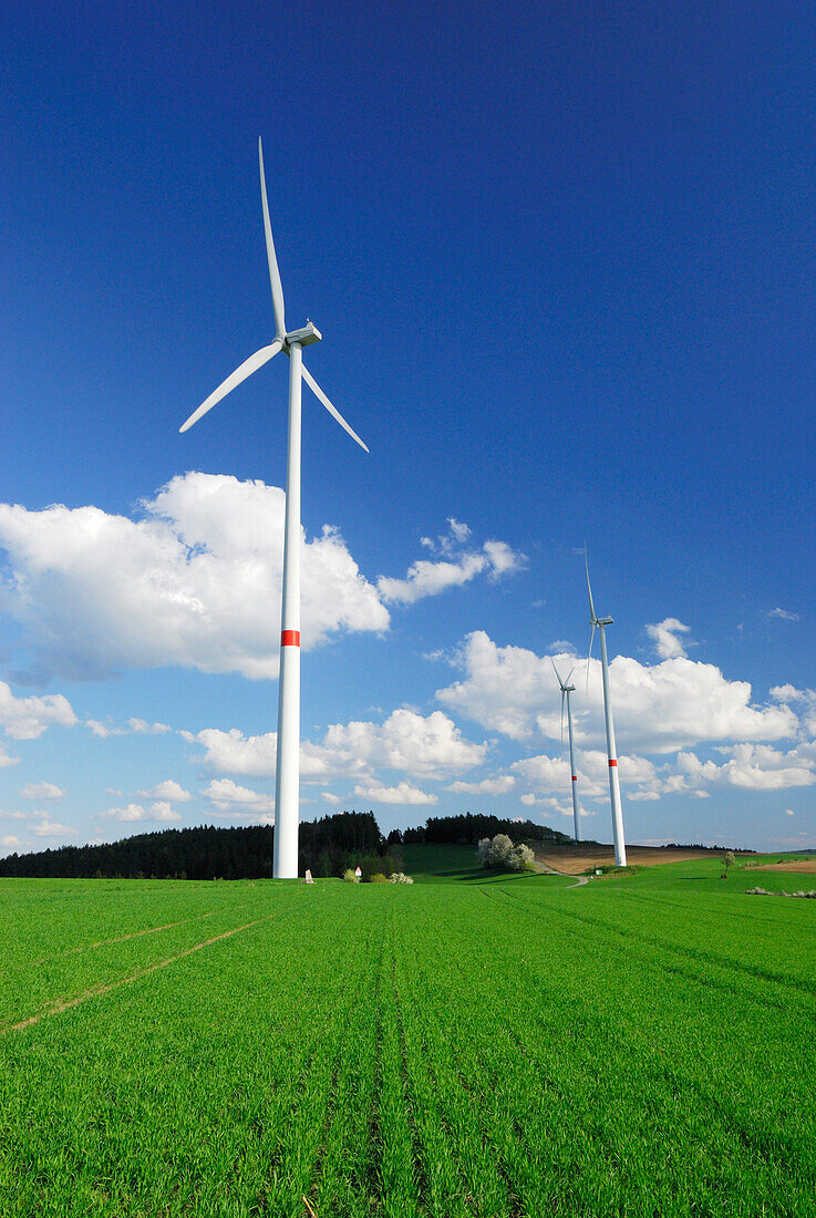 Three wind turbines in meadow, Bavaria, Germany