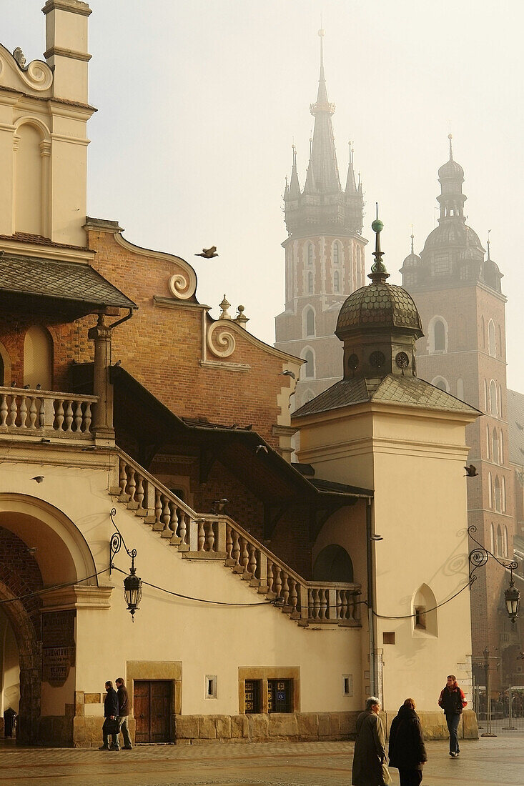 Rynek Glowny (Main Market Square): Sukiennice (Cloth Hall) and St Marys basilica in background, Krakow. Poland