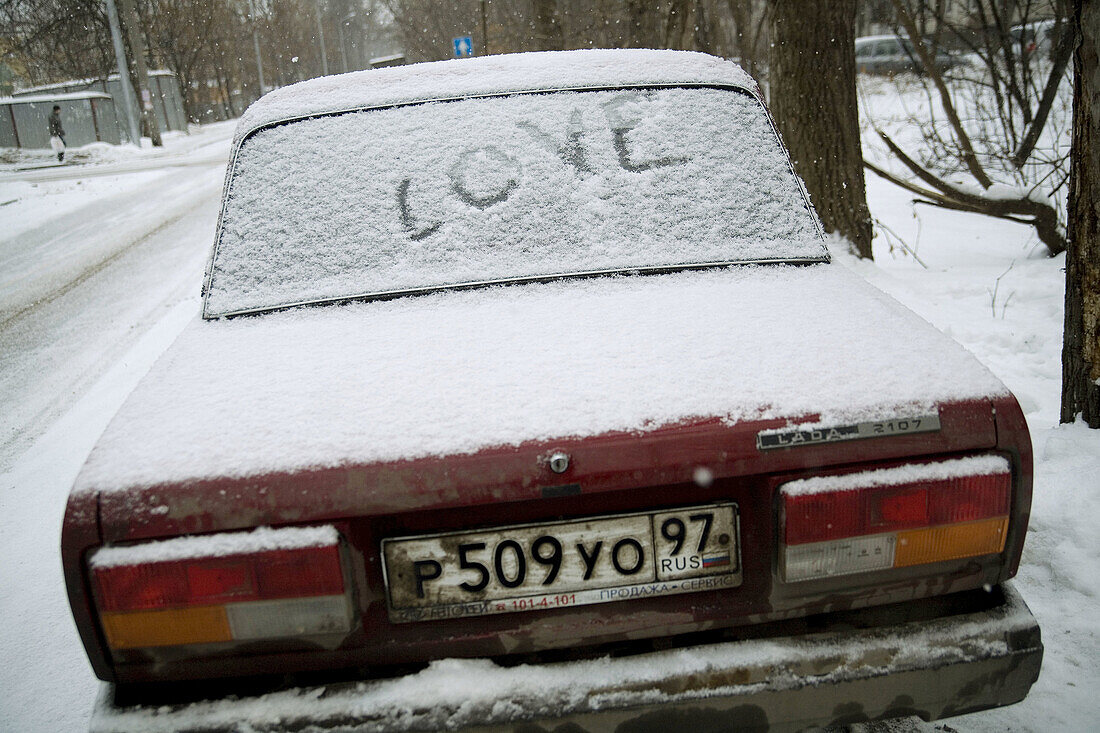 Love on snow-covered car, Moscow, Russia