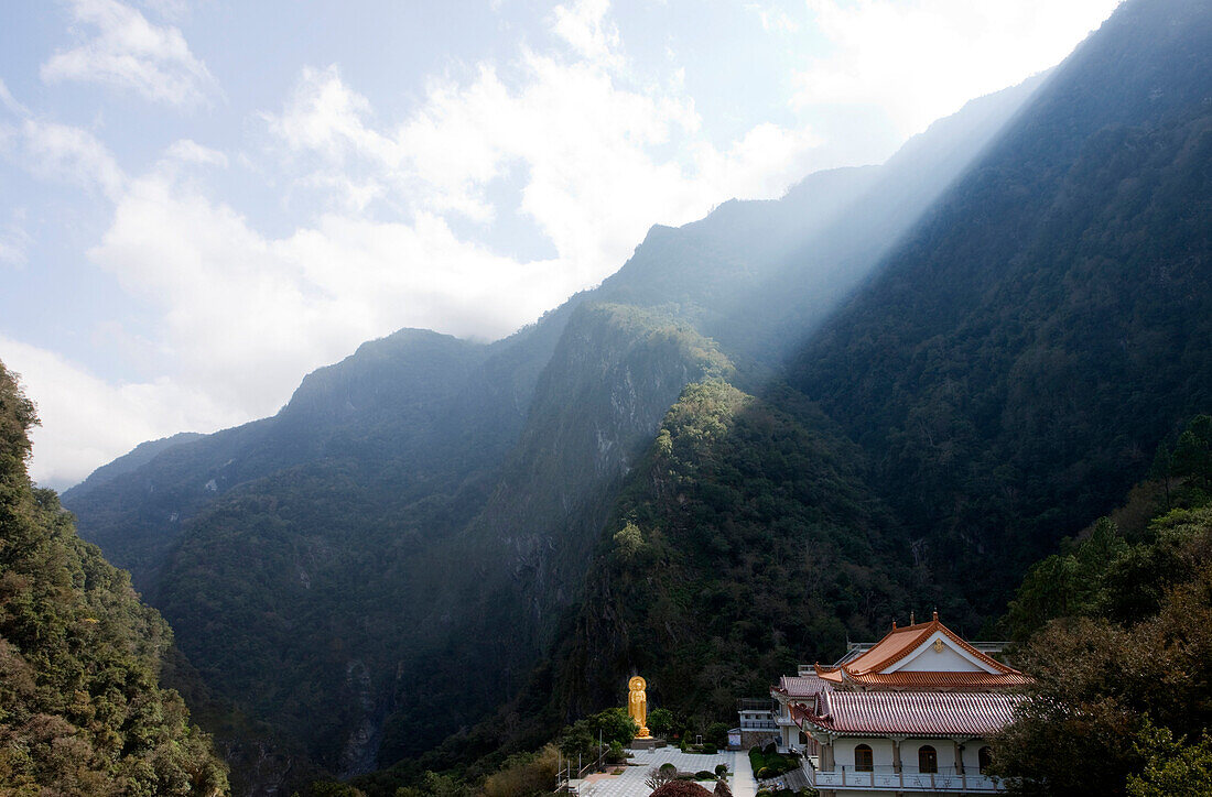 Sonnenstrahlen scheinen über die Berge, Blick auf Hsiang-Te Tempel und Buddhastatue, Tienhsiang, Taroko Schlucht, Taroko Nationalpark, Taiwan, Asien